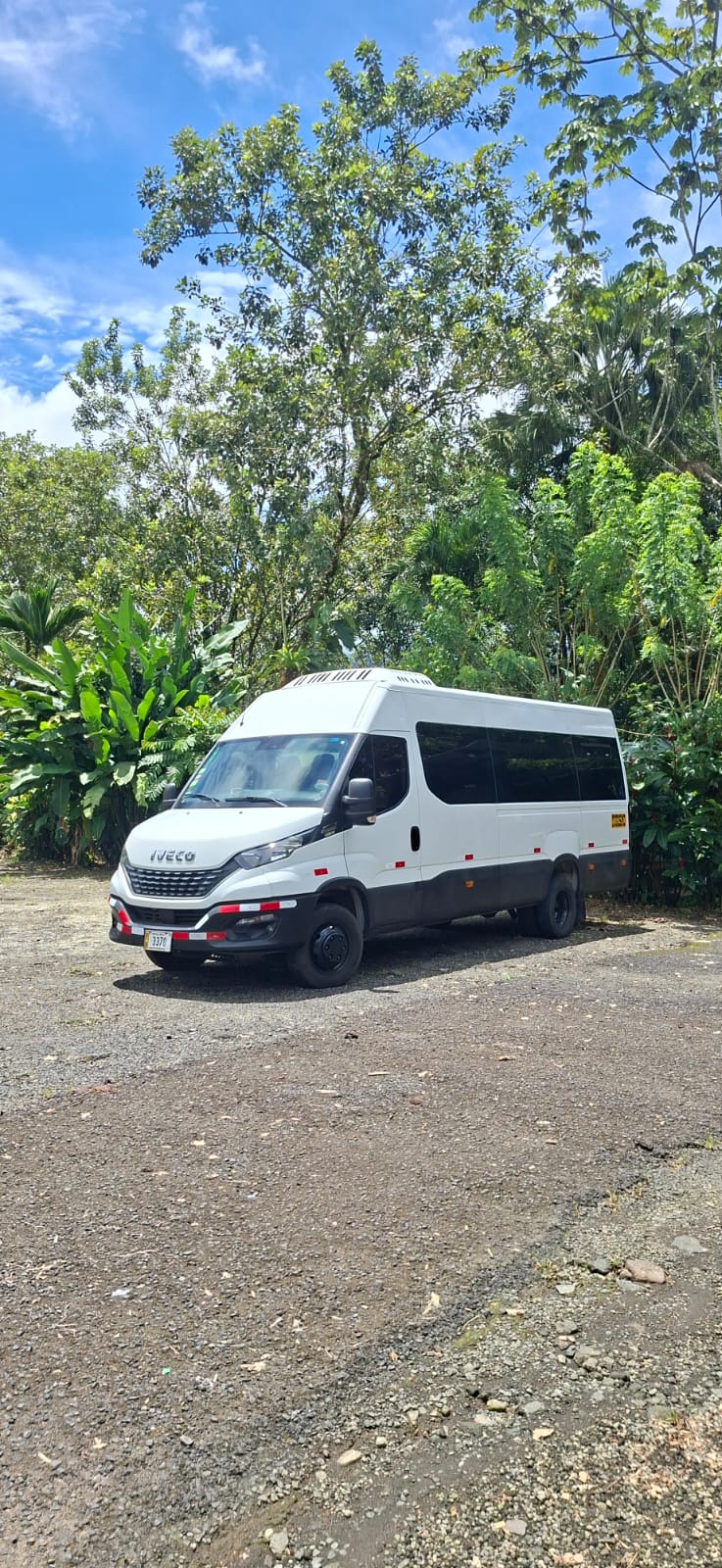 Lora Rentals private transportation van in a tropical setting